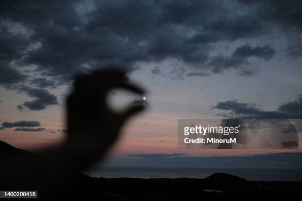 a hand trying to catch the moon - every cloud has a silver lining stock pictures, royalty-free photos & images
