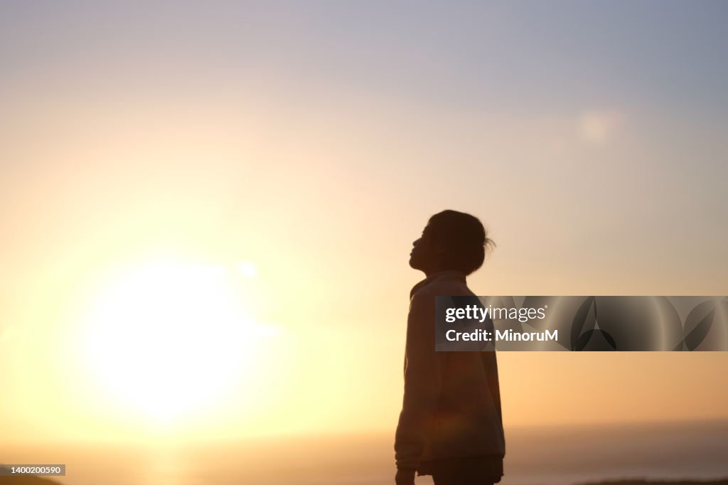 Silhouette of boy in morning glow