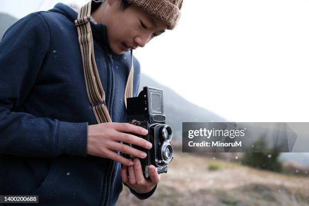 boy holding a medium format camera - teenager dream work bildbanksfoton och bilder