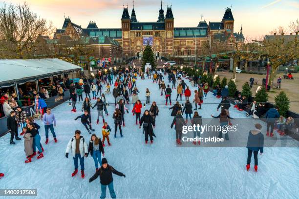 ice rink rijksmuseum on a bright day during winter in amsterdam. the netherlands - museumplein stockfoto's en -beelden