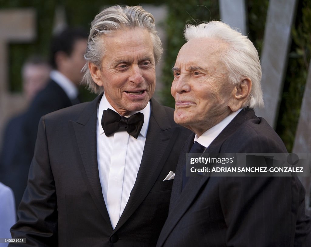 Michael Douglas (L) greets his father Ki