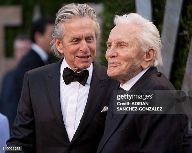 Michael Douglas greets his father Kirk Douglas on the carpet as they arrive at the Vanity Fair Oscar Party, for the 84th Annual Academy Awards, at...