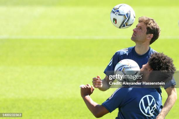 Thomas Müller and team mate Serge Gnabry plays with the ball during a training session of the German national soccer team at adidas Herzo Base...