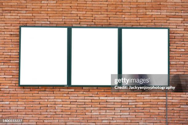 blank billboard on the brick wall - poster wall stock-fotos und bilder