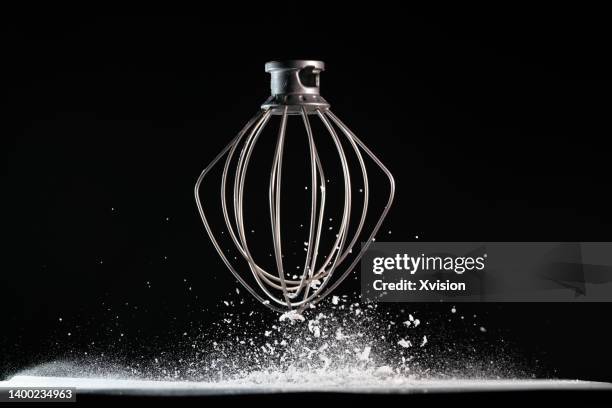 egg beater blender flying in mid air in black background - egg white shake stock pictures, royalty-free photos & images