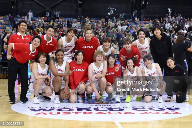 Japan pose for a team photo after victory during game three of the International Series between the Australian Opals and Japan at the Newcastle...