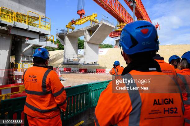 Construction workers look on as a 700 tonne ‘bridge-building machine’ begins to build the Colne Valley Viaduct for the HS2 project on May 31, 2022 in...