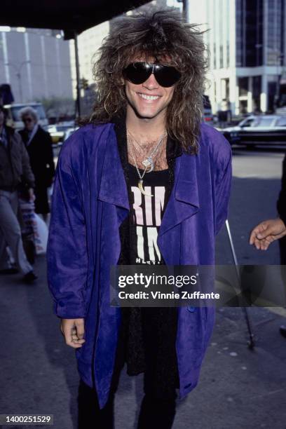 American singer, songwriter and guitarist Jon Bon Jovi, wearing a blue jacket and sunglasses, at the Hard Rock Cafe in New York City, New York, 30th...