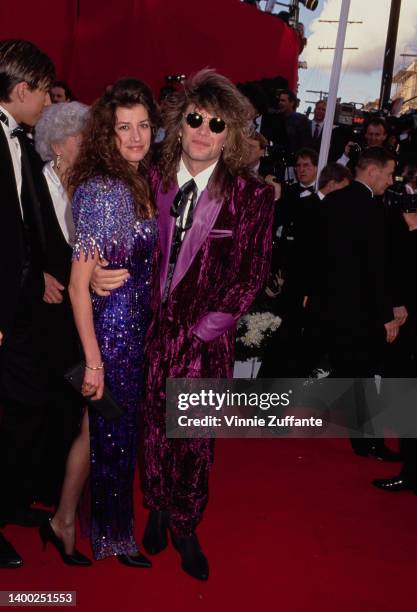 American singer, songwriter and guitarist Jon Bon Jovi, wearing a purple velvet suit, and his wife, Dorothea Hurley attend the 63rd Academy Awards,...