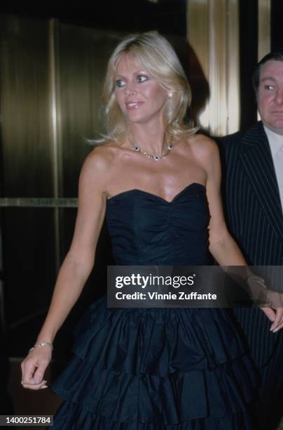 Swedish actress and singer Britt Ekland, wearing a strapless black dress with a sweetheart neckline, United States, circa 1997.