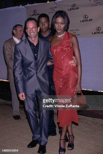 American photographer Herb Ritts and British fashion model Naomi Campbell, wearing a red one-shoulder dress, attends the inaugural 'A Tribute To...