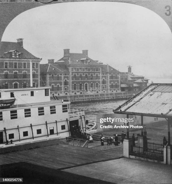 The passenger barge 'Louisa C' landing at the Ellis Island immigrant inspection station in Upper New York Bay, New York City, New York, circa 1895....