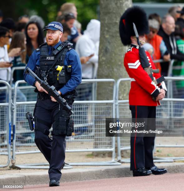 Metropolitan Police firearms officer patrols The Mall ahead of the Colonel's Review at Horse Guards Parade on May 28, 2022 in London, England. The...
