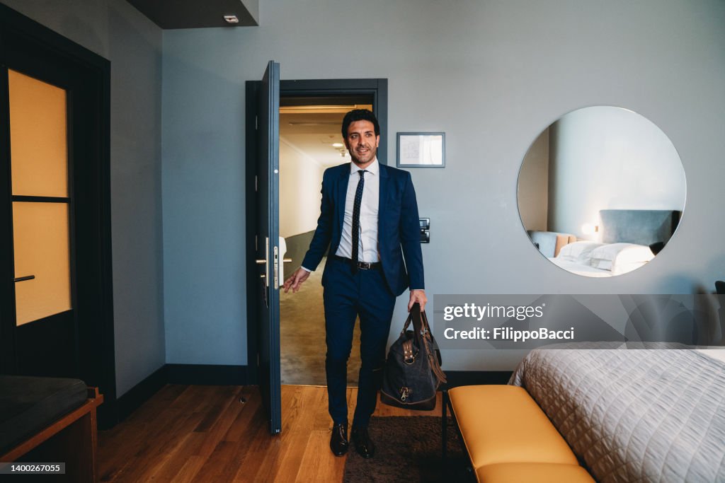 A businessman is entering in an hotel room