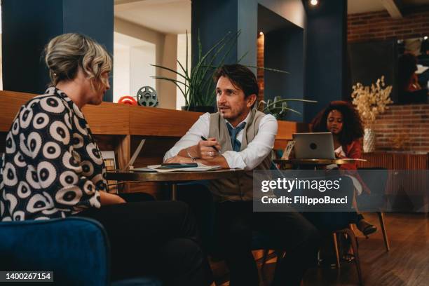 business people are talking together in an hotel hall - hotel lobby imagens e fotografias de stock