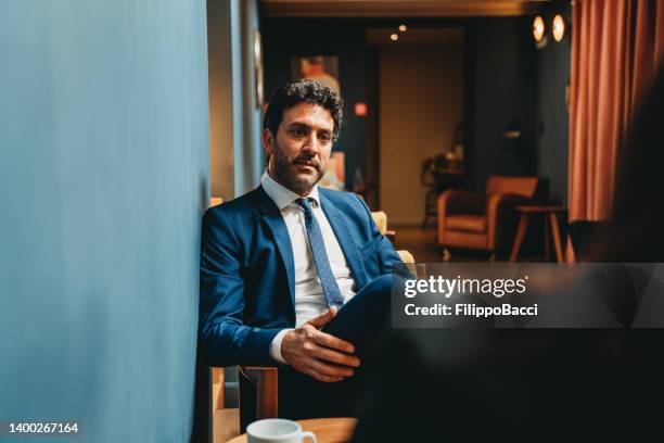 business people are talking together in an hotel hall - hotel lobby imagens e fotografias de stock