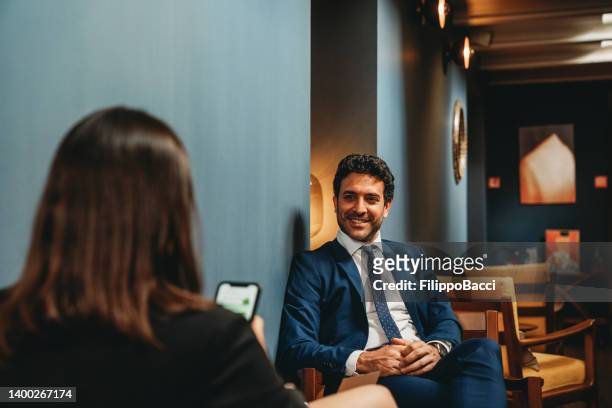 business people are talking together in an hotel hall - hotel lobby imagens e fotografias de stock