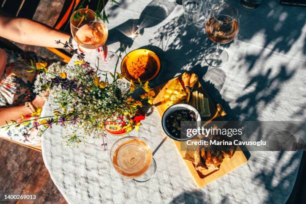 group of female friends drinking wine outside. - antipasto stock pictures, royalty-free photos & images