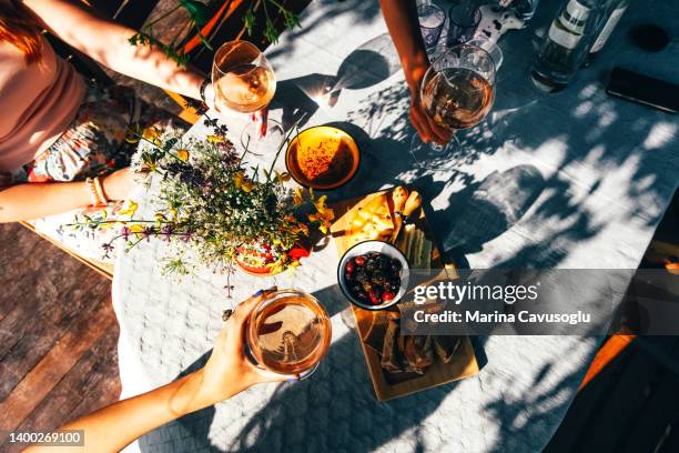 group of female friends drinking wine outside. - italian food and wine stock pictures, royalty-free photos & images