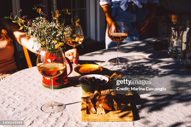 wine glasses and appetisers on the table - antipasto stock pictures, royalty-free photos & images