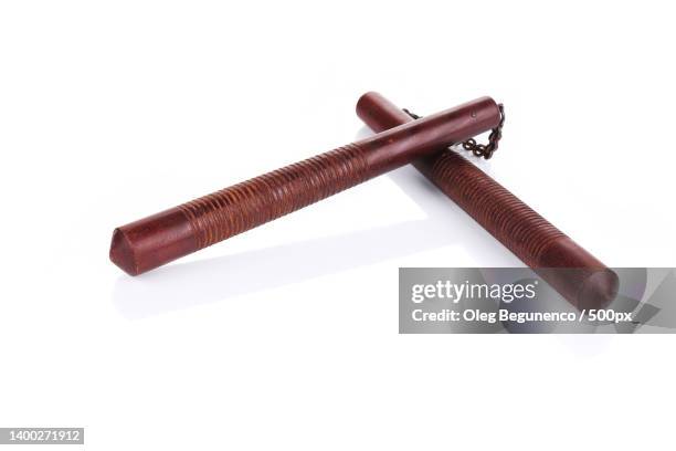 martial arts nunchaku weapon against white background,moldova - nunchucks stock pictures, royalty-free photos & images