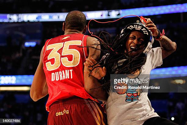 All-Star MVP Kevin Durant of the Oklahoma City Thunder and the Western Conference celebrates with hip-hop artist Lil' Wayne during the 2012 NBA...