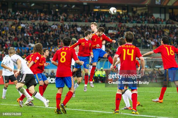 Sergio Ramos and Gerard Pique of Spain and Per Mertesacker of Germany in action during the World Cup Semi Final match between Spain and Germany at...