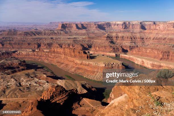 aerial view of rock formations against cloudy sky,dead horse point state park,united states,usa - mark colvin stock pictures, royalty-free photos & images