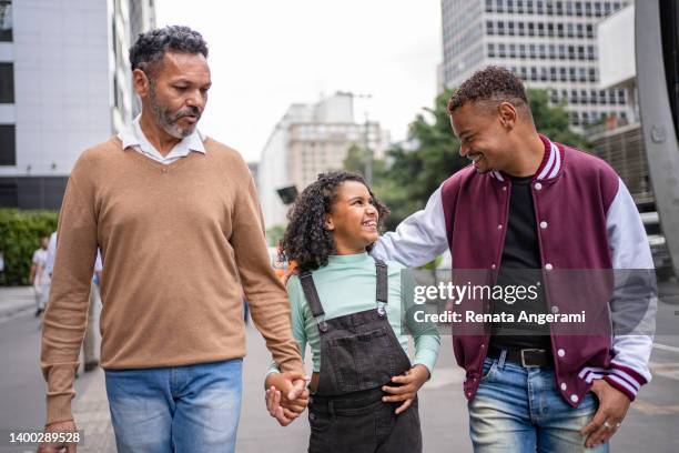 Gay couple with adopted girl at Paulista Avenue in Sao Paulo , Brazil