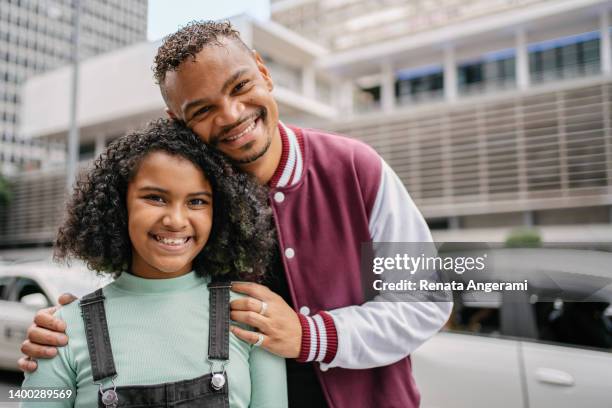 gay couple with adopted girl at paulista avenue in sao paulo , brazil - foster care stock pictures, royalty-free photos & images