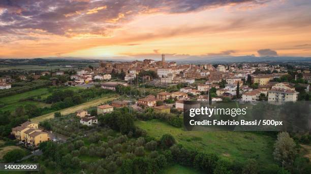 high angle view of townscape against sky at sunset,foiano della chiana,arezzo,italy - arezzo stock-fotos und bilder