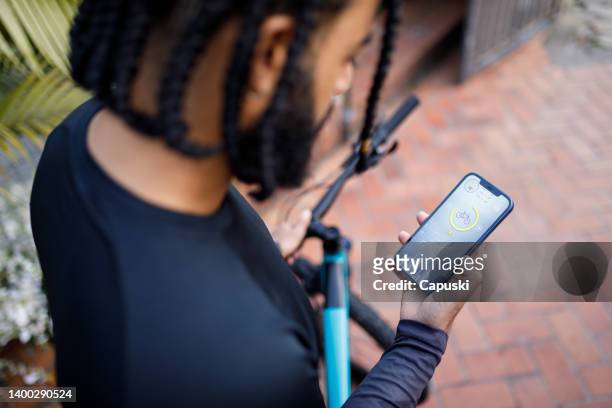 man checking his performance on fitness app - sportsman stock pictures, royalty-free photos & images