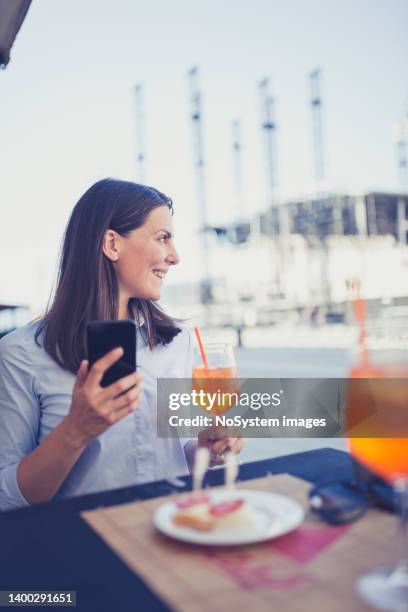 businesswoman using mobile phone in cafe - illegal drugs at work stock pictures, royalty-free photos & images