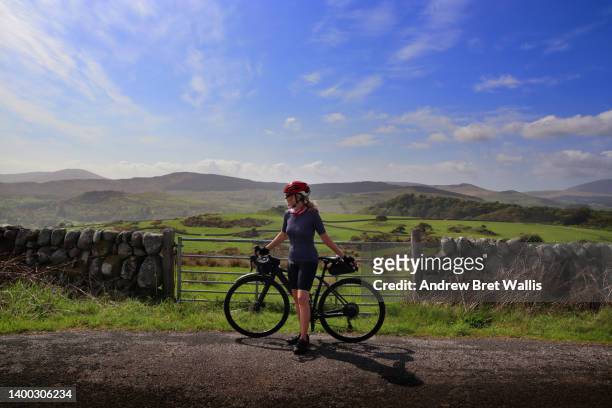 solo female cyclist takes the road less travelled - dumfries - fotografias e filmes do acervo