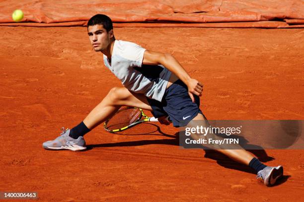Carlos Alcaraz of Spain hits a forehand against Alexander Zverev of Germany in the quarter finals of the men's singles at Roland Garros on May 30,...