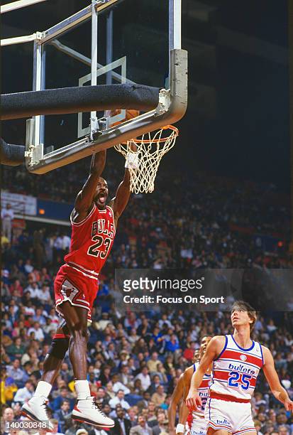 Michael Jordan of the Chicago Bulls goes in for a two handed slam against the Washington Bullets during an NBA basketball game circa 1986 at the...