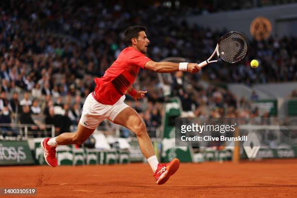 Novak Djokovic of Serbia stretches to play a forehand against Rafael Nadal of Spain during the Men's Singles Quarter Final match on Day 10 of The...