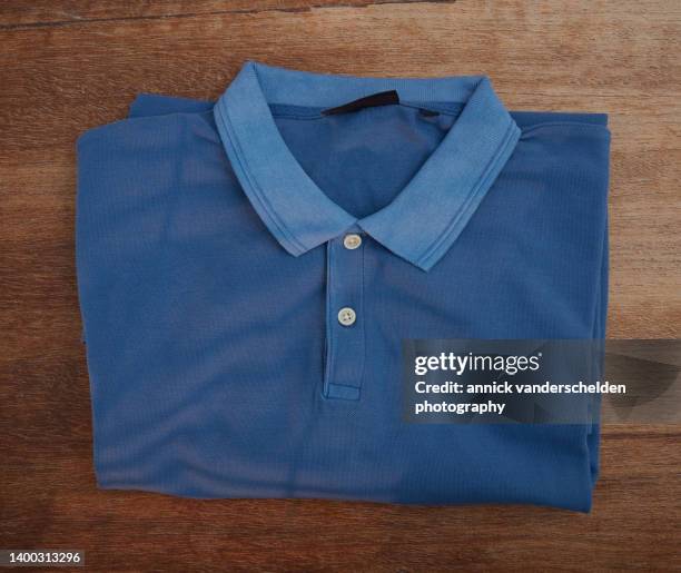 blue polo shirt - shirt no people stock-fotos und bilder