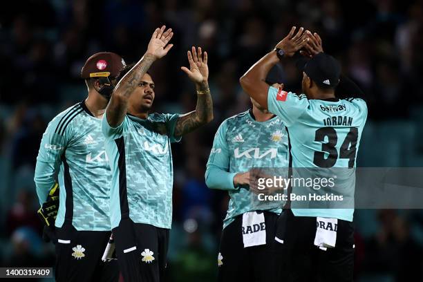 Sunil Narine of Surrey celebrates with team mates after taking the wicket of Benny Howell of Gloucestershire during the Vitality T20 Blast match...