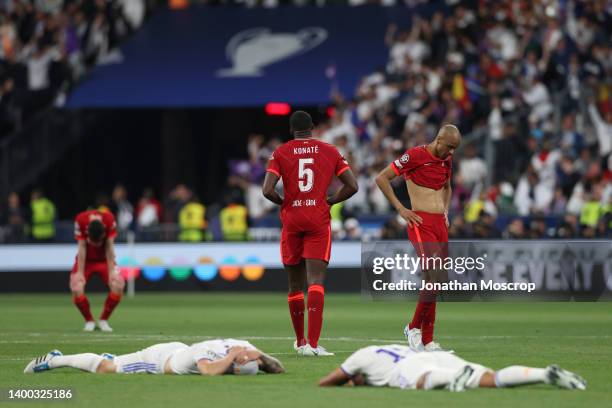 Andrew Robertson, Ibrahima Konate and Fabinho of Liverpool FC react following the final whistle of the UEFA Champions League final match between...