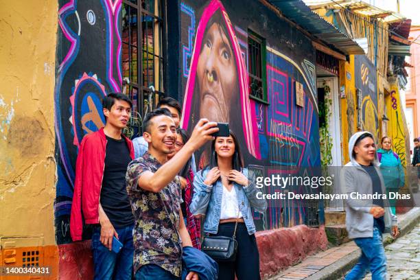 bogota, colombia - tourists and selfies on the calle del embudo, in the historic la candelaria district of the andes capital city in south america. - embudo bildbanksfoton och bilder