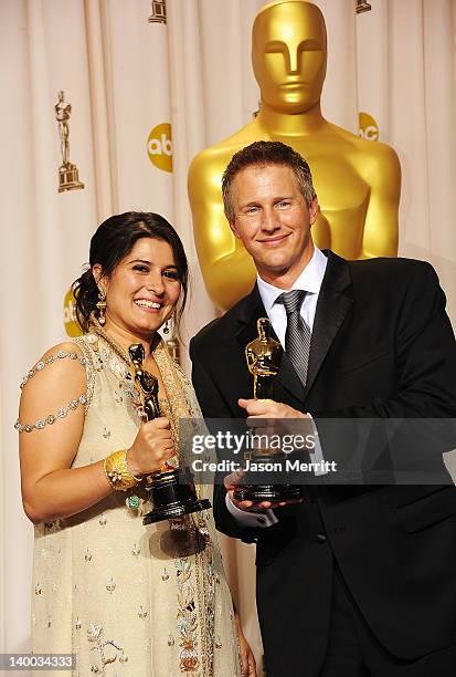 Filmmakers Daniel Junge and Sharmeen Obaid-Chinoy , winners of Best Documentary Short Award for 'Saving Face,' pose in the press room at the 84th...