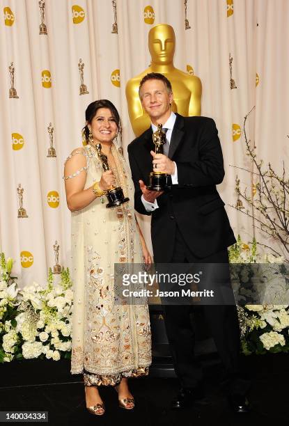 Filmmakers Daniel Junge and Sharmeen Obaid-Chinoy , winners of Best Documentary Short Award for 'Saving Face,' pose in the press room at the 84th...