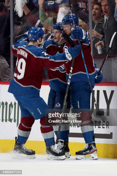 Cale Makar of the Colorado Avalanche celebrates with Valeri Nichushkin and Nathan MacKinnon after scoring a goal against the Edmonton Oilers during...