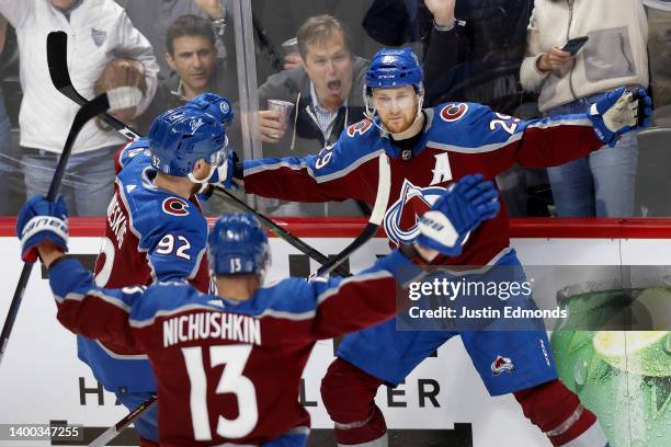 Nathan MacKinnon of the Colorado Avalanche celebrates with teammates Gabriel Landeskog and Valeri Nichushkin after scoring a goal against the...