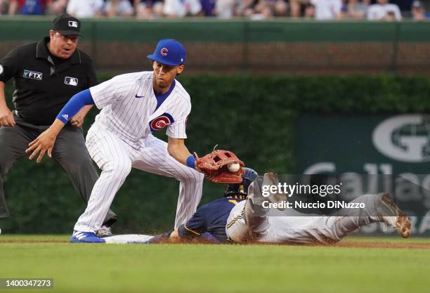 Keston Hiura of the Milwaukee Brewers steals second base against Andrelton Simmons of the Chicago Cubs during the second inning of a game at Wrigley...