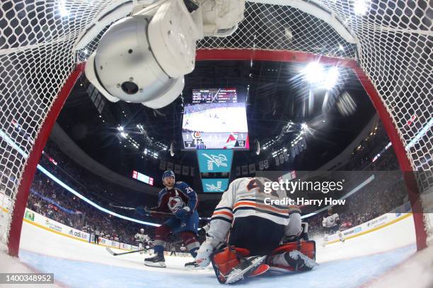 Nathan MacKinnon of the Colorado Avalanche scores a goal on Mike Smith of the Edmonton Oilers during the first period in Game One of the Western...