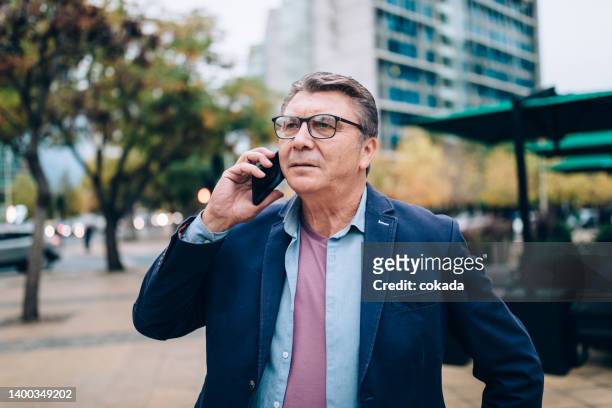 businessman using cell phone at downtown santiago - chilean ethnicity stock pictures, royalty-free photos & images