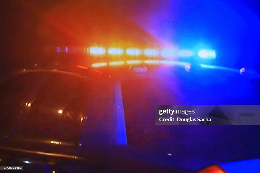 Police car - fast moving with bright flashing lights