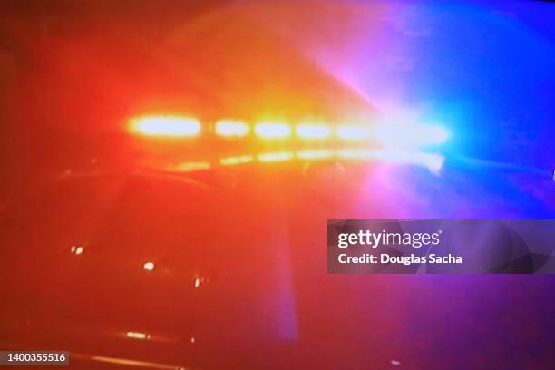 bright flashing lights from a police car - police lights fotografías e imágenes de stock
